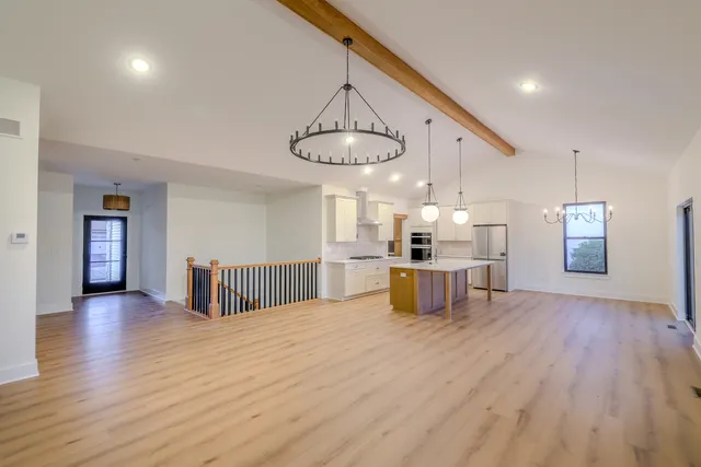 a kitchen with stainless steel appliances kitchen island a large island in the center