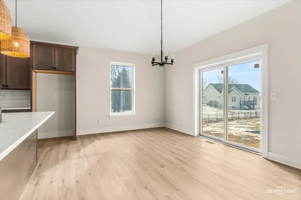 a view of kitchen with furniture and wooden floor