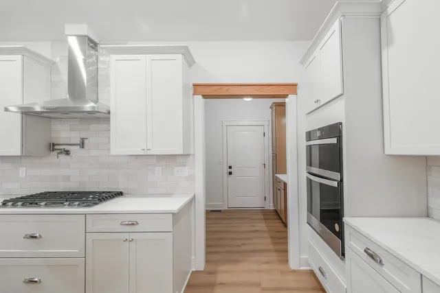 a kitchen with stainless steel appliances granite countertop a stove and a refrigerator
