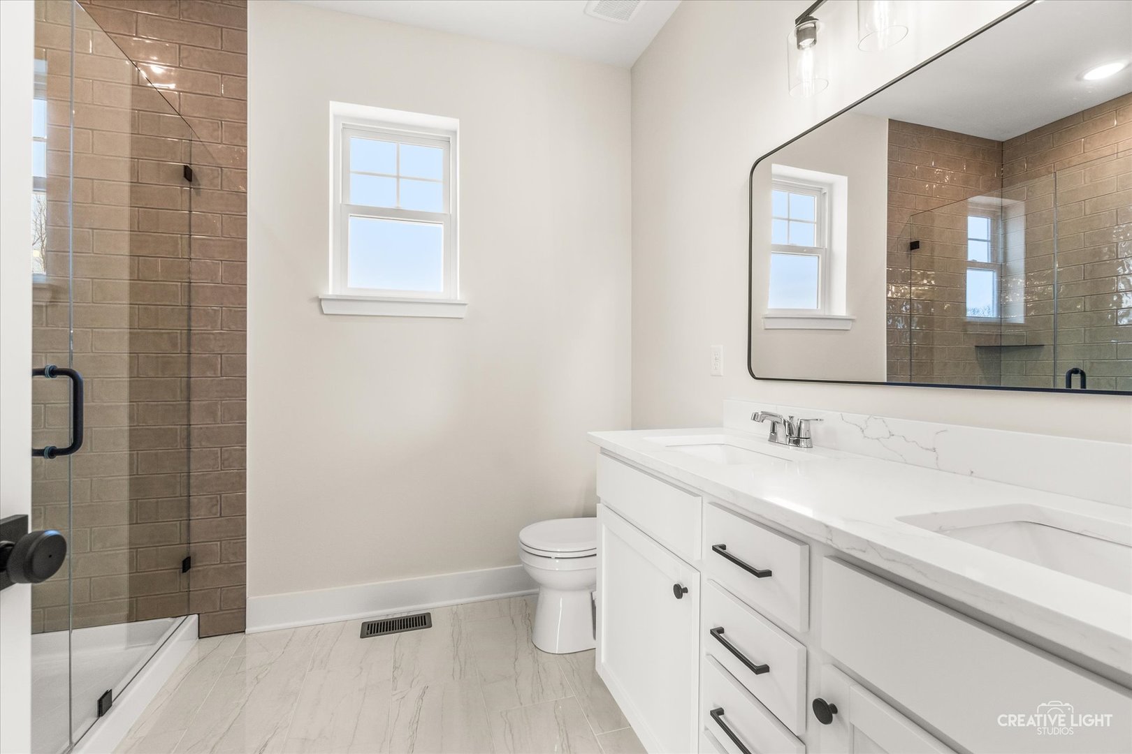 1823 Constitution Street Sycamore, IL 60178 - Photo 10 of 18 a bathroom with a sink a toilet and shower