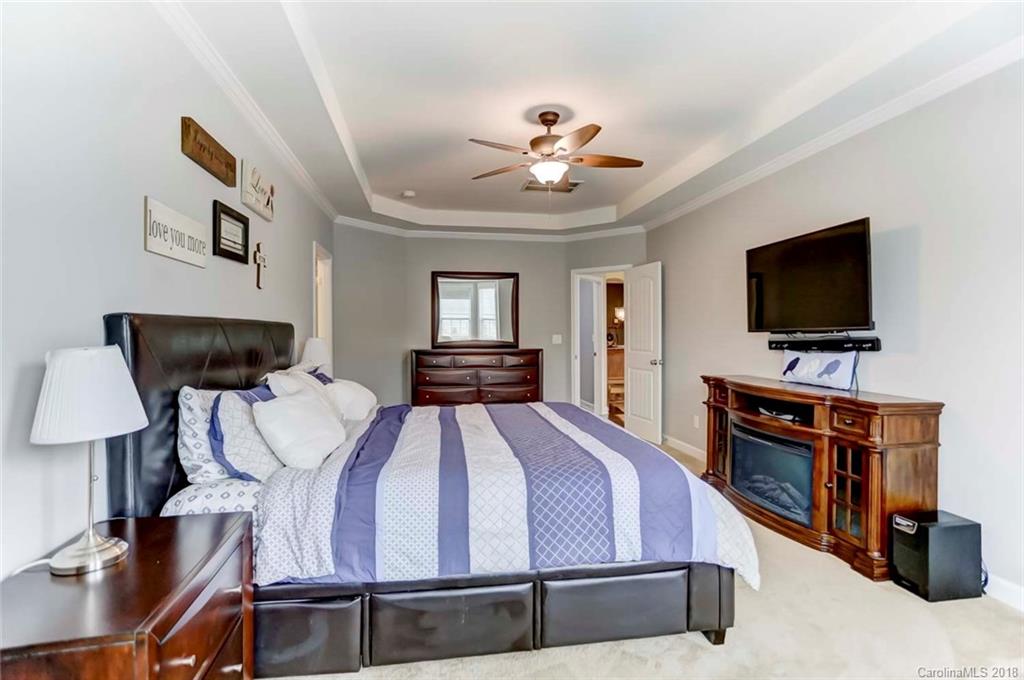 516 Rosemary Lane Fort Mill, SC 29708 - Photo 17 of 36 a spacious bedroom with a bed and a flat screen tv