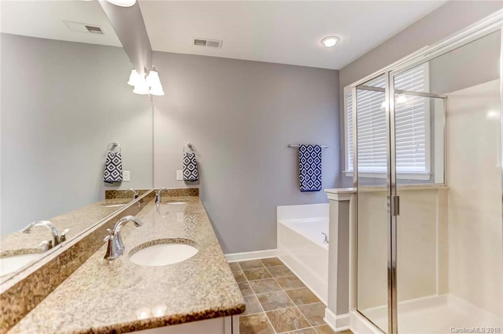 516 Rosemary Lane Fort Mill, SC 29708 - Photo 18 of 36 a bathroom with a granite countertop sink a mirror and vanity