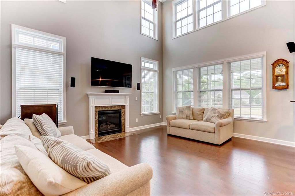 516 Rosemary Lane Fort Mill, SC 29708 - Photo 3 of 36 a living room with furniture a flat screen tv and a fireplace