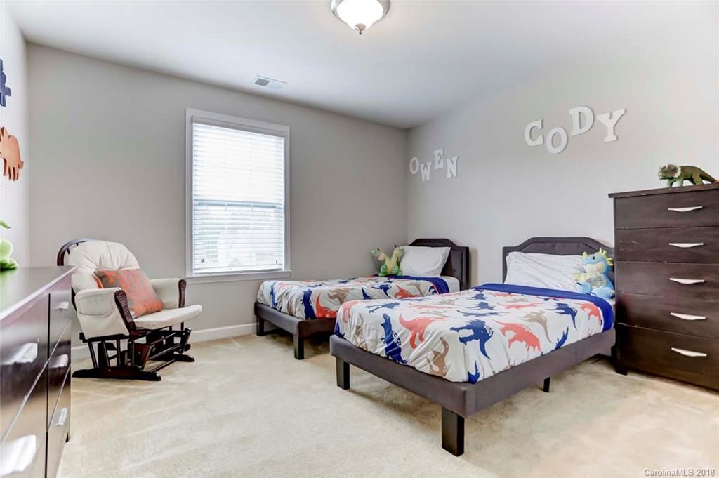 516 Rosemary Lane Fort Mill, SC 29708 - Photo 21 of 36 a bedroom with two beds and a window
