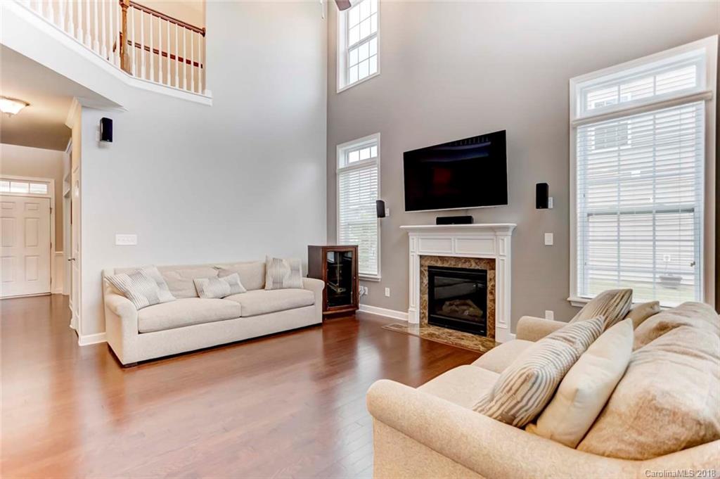 516 Rosemary Lane Fort Mill, SC 29708 - Photo 4 of 36 a living room with furniture a fireplace and a flat screen tv