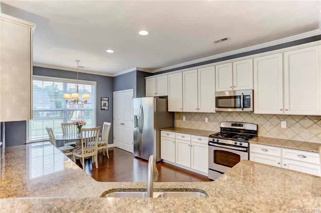 516 Rosemary Lane Fort Mill, SC 29708 - Photo 7 of 36 a kitchen with stainless steel appliances granite countertop a refrigerator stove microwave and sink