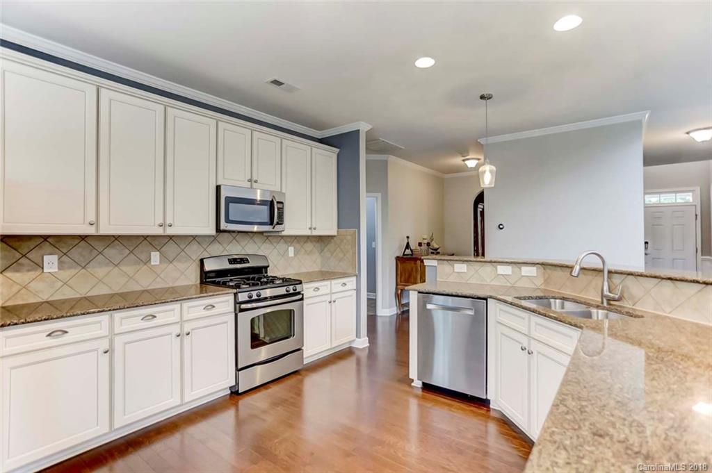 516 Rosemary Lane Fort Mill, SC 29708 - Photo 10 of 36 a kitchen with granite countertop white cabinets and white stainless steel appliances