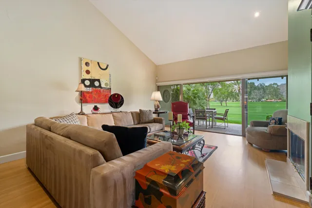 a living room with furniture and a floor to ceiling window