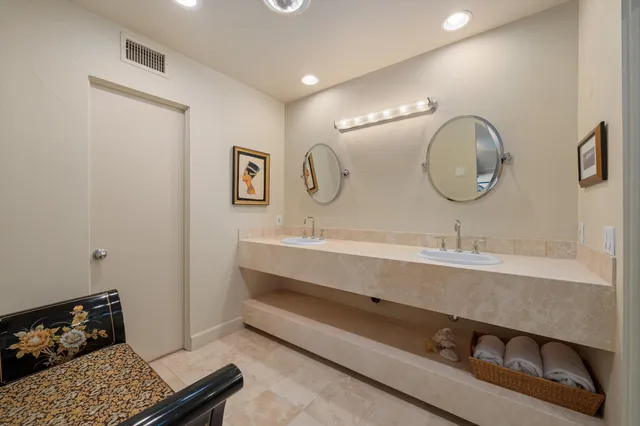 a bathroom with a sink mirror and vanity