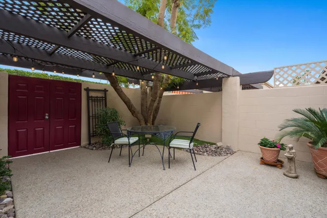 a patio with table and chairs