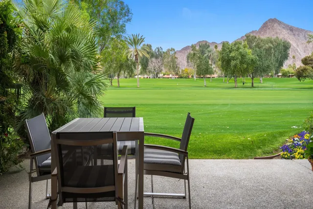 a view of a chairs and table in the garden