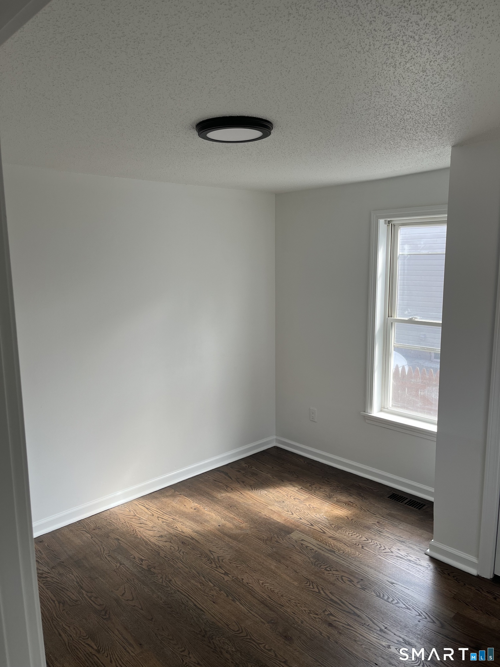 52 Pearl Street Manchester, CT 06040 - Photo 11 of 31 an empty room with wooden floor and windows