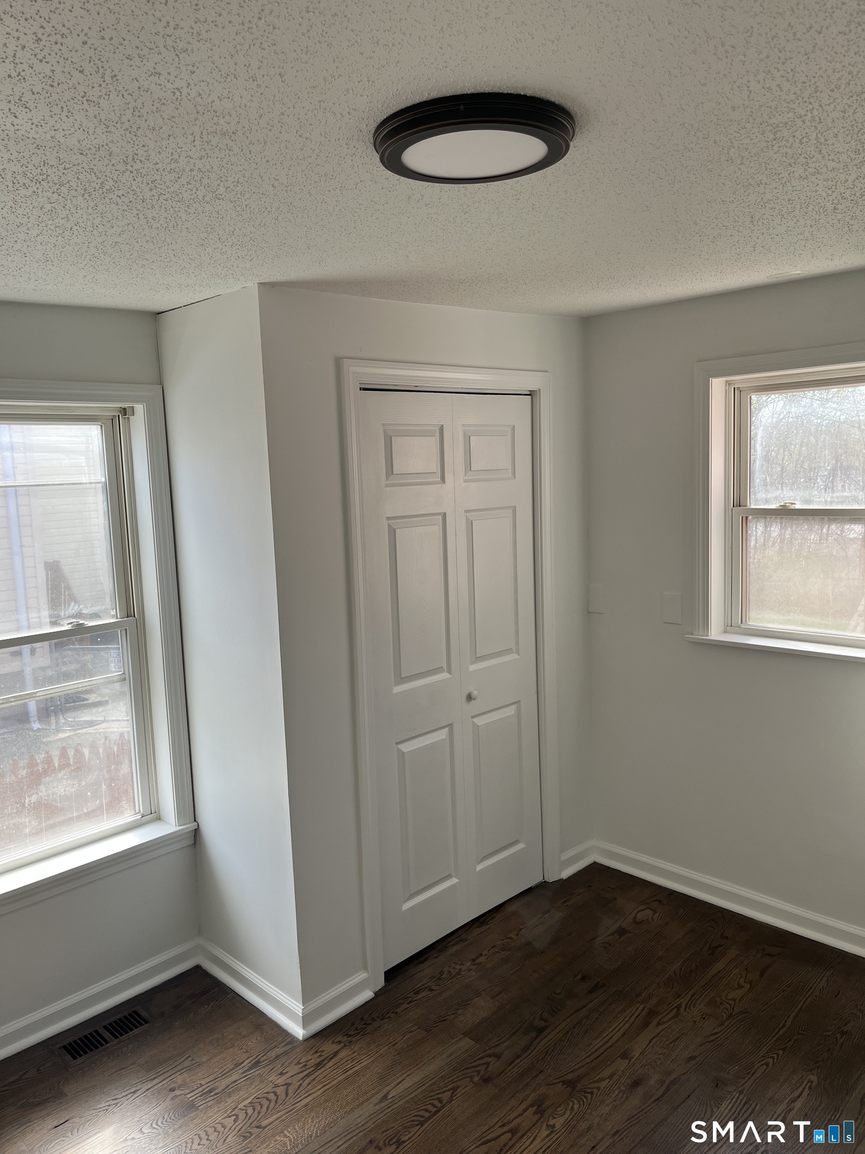 52 Pearl Street Manchester, CT 06040 - Photo 12 of 31 an empty room with wooden floor and windows