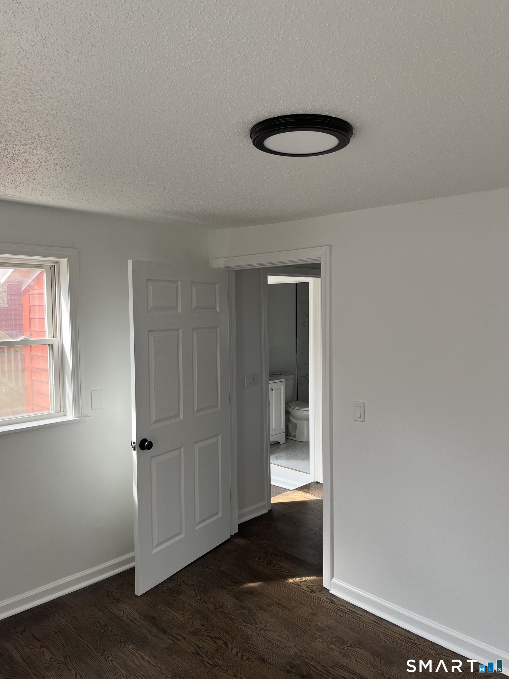 52 Pearl Street Manchester, CT 06040 - Photo 13 of 31 an empty room with wooden floor and windows