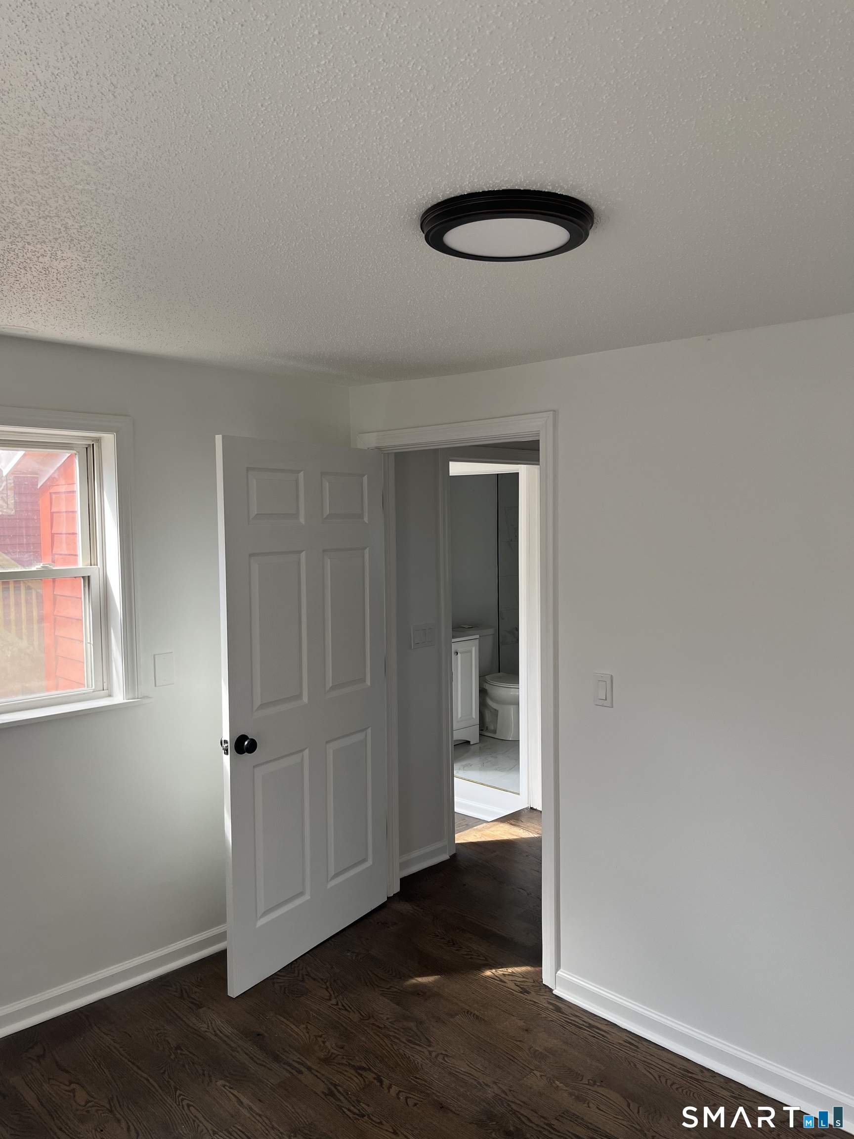 52 Pearl Street Manchester, CT 06040 - Photo 14 of 31 an empty room with wooden floor and windows