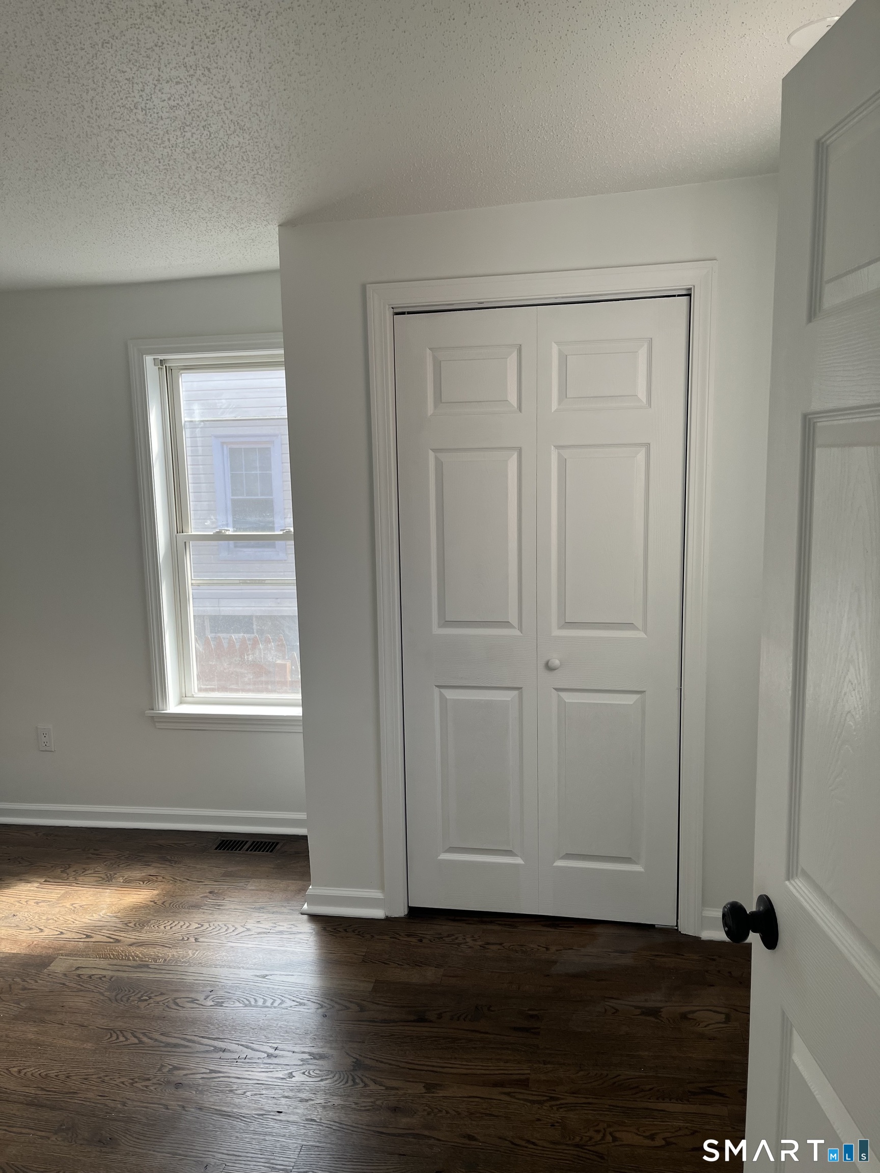 52 Pearl Street Manchester, CT 06040 - Photo 16 of 31 an empty room with wooden floor and windows