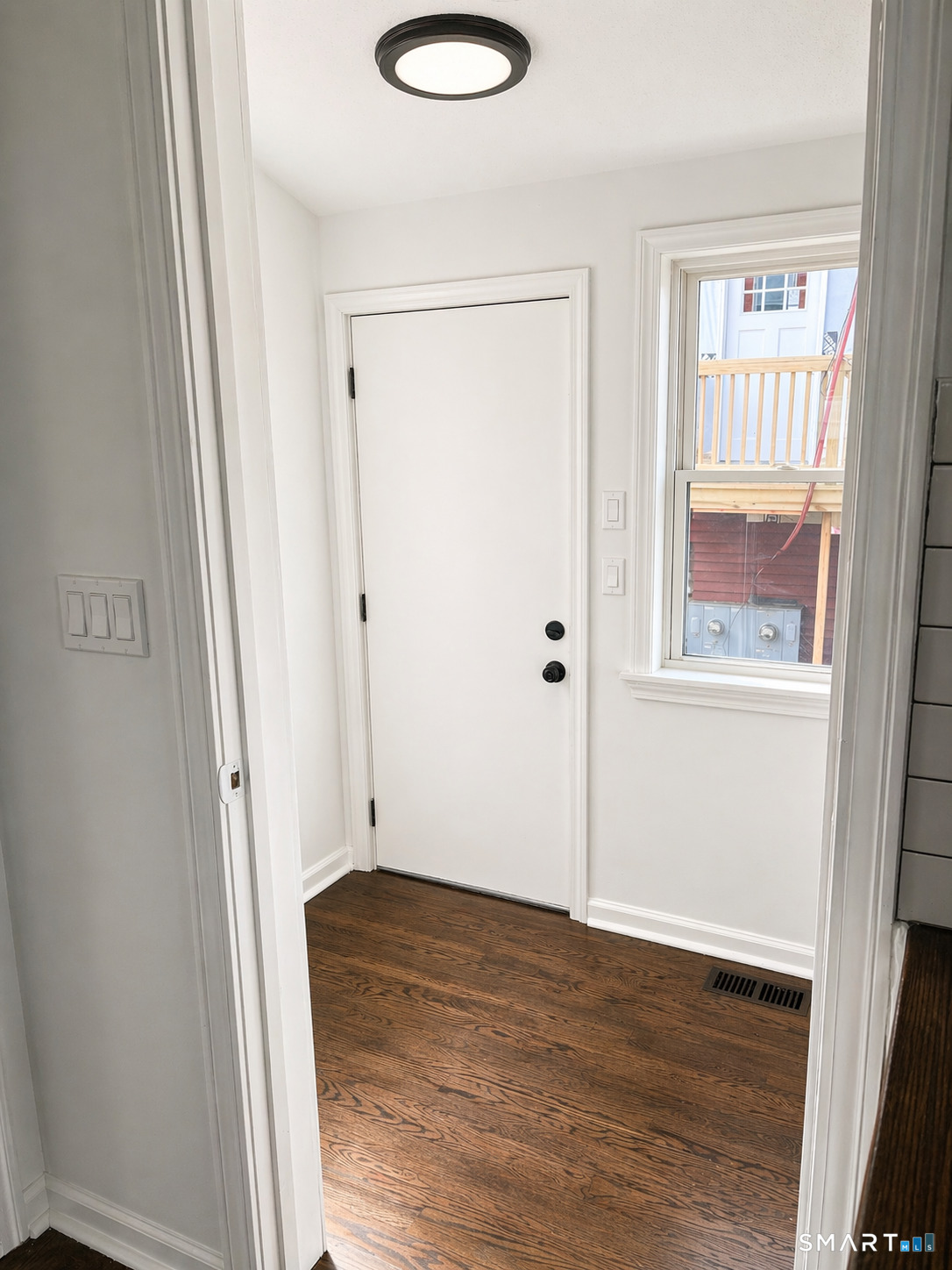 52 Pearl Street Manchester, CT 06040 - Photo 4 of 31 an empty room with wooden floor and windows
