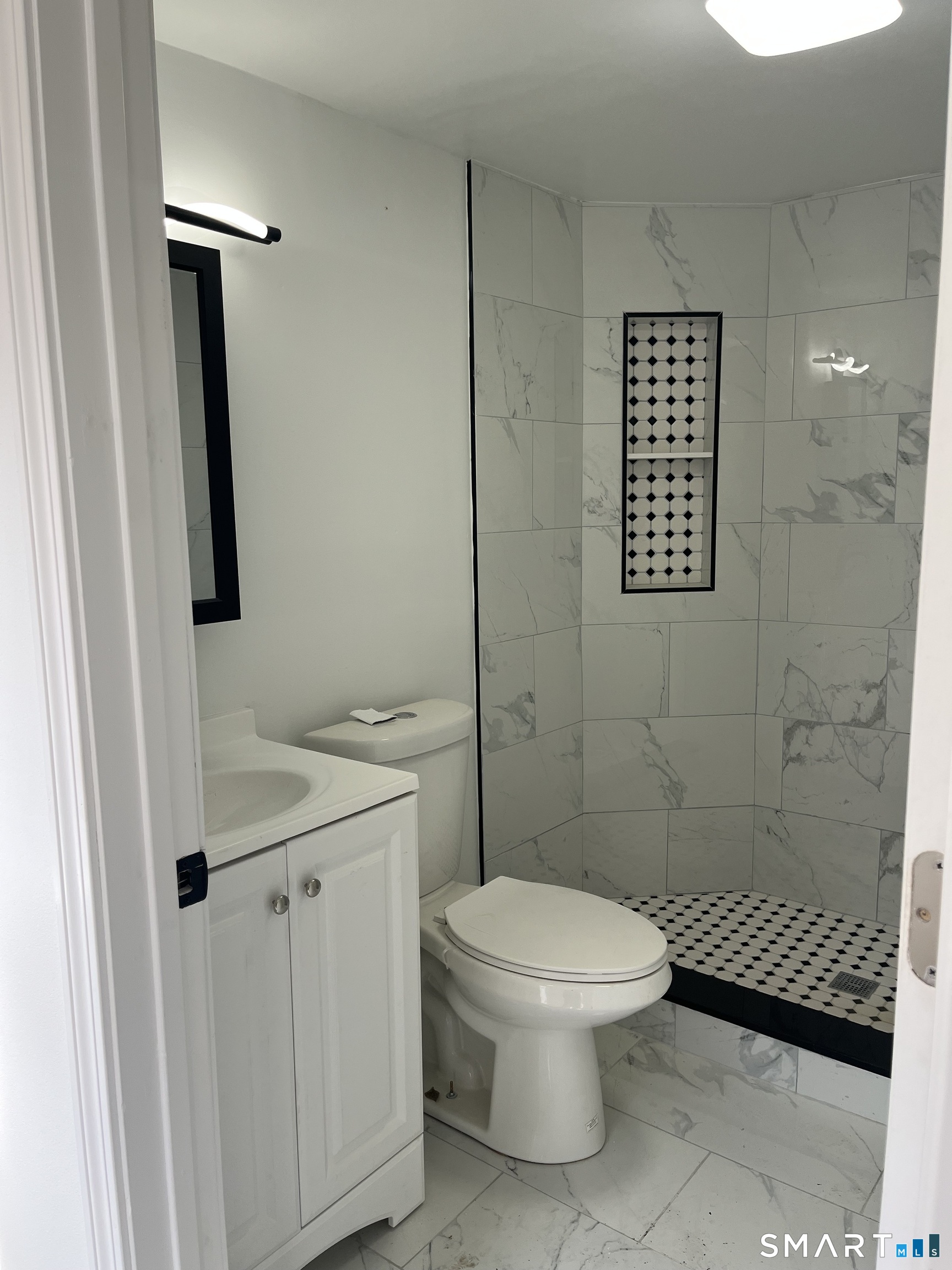 52 Pearl Street Manchester, CT 06040 - Photo 5 of 31 a bathroom with a toilet sink and shower