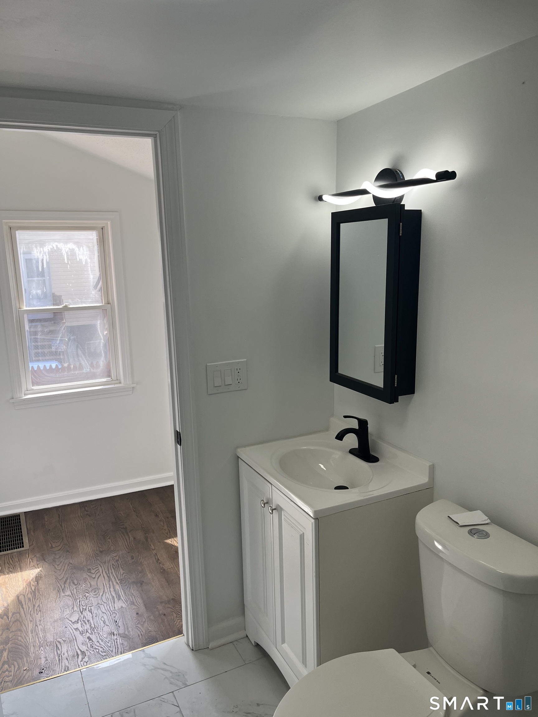 52 Pearl Street Manchester, CT 06040 - Photo 6 of 31 a bathroom with a toilet sink and mirror