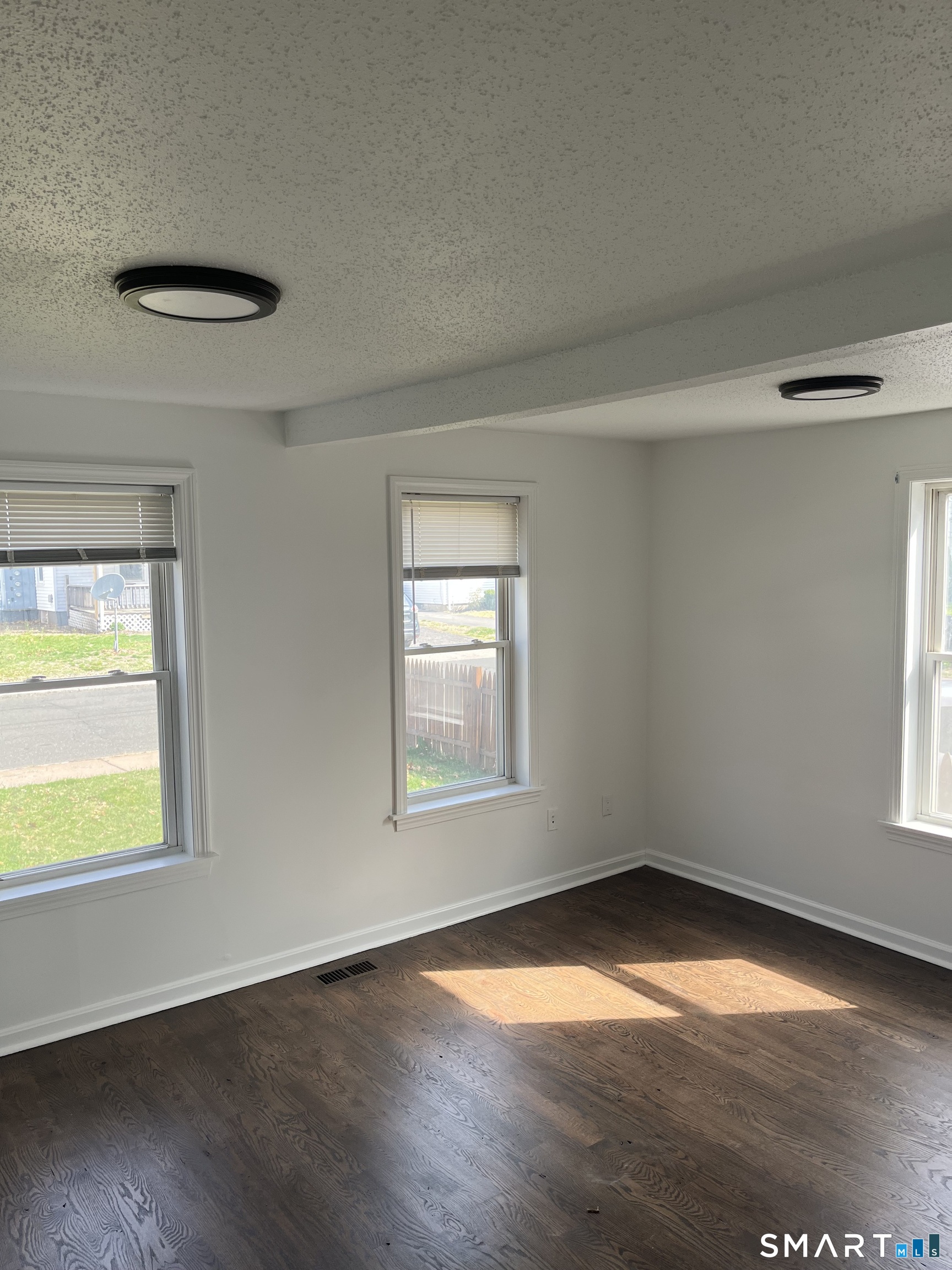 52 Pearl Street Manchester, CT 06040 - Photo 10 of 31 an empty room with wooden floor and windows