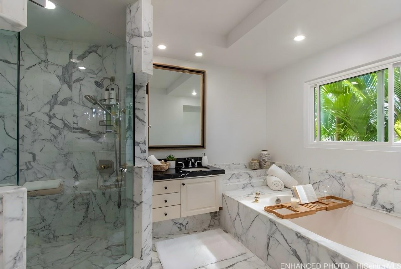 235 Portlock Road Honolulu, HI 96825 - Photo 11 of 21 a bathroom with a sink toilet a mirror and shower