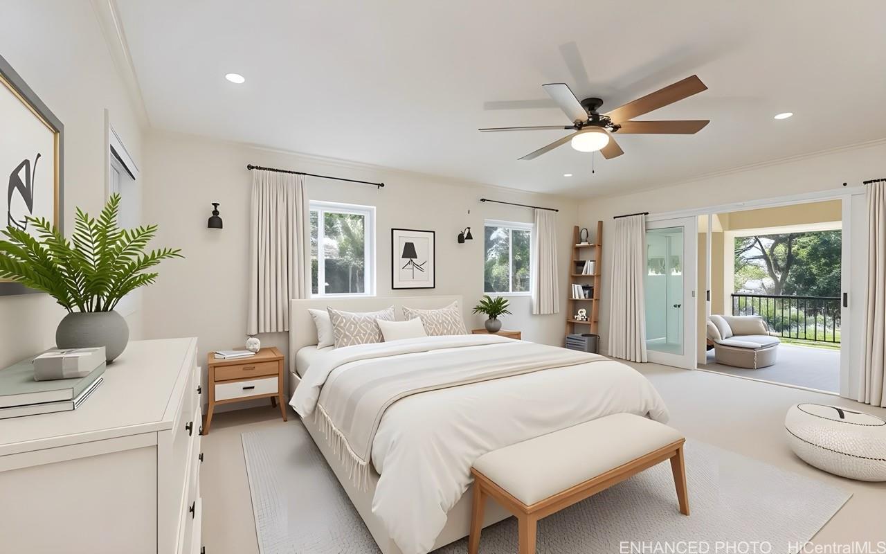 235 Portlock Road Honolulu, HI 96825 - Photo 12 of 21 a bedroom with a large bed and a chandelier