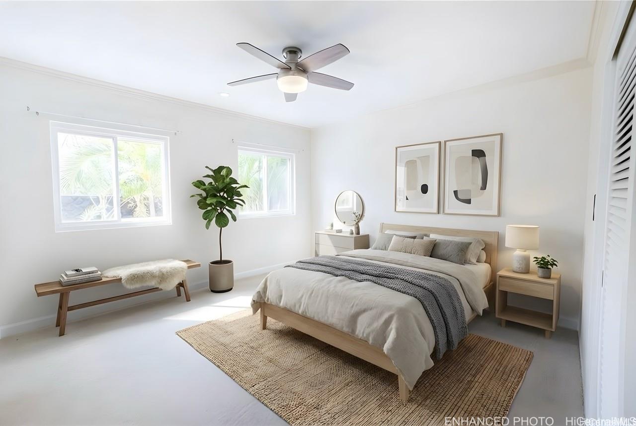 235 Portlock Road Honolulu, HI 96825 - Photo 14 of 21 a bedroom with a bed couch and a window