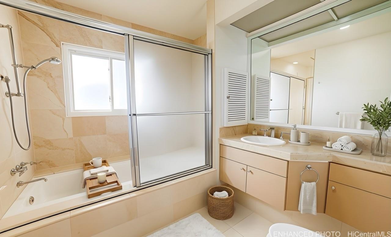235 Portlock Road Honolulu, HI 96825 - Photo 15 of 21 a bathroom with a granite countertop sink a mirror a bathtub and shower