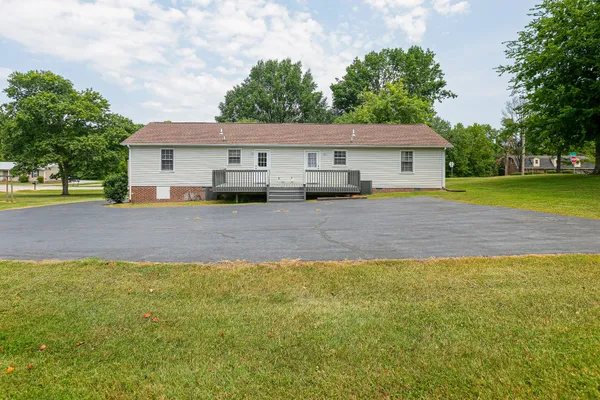 a view of a house with a yard and tree