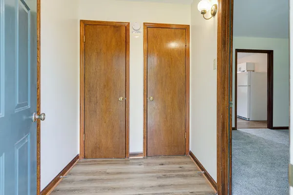 a view of a hallway with wooden floor