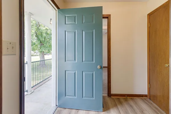 a view of front door with wooden floor