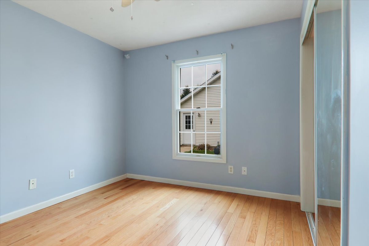 1401 River Landing Street Normal, IL 61761 - Photo 14 of 27 an empty room with wooden floor and windows