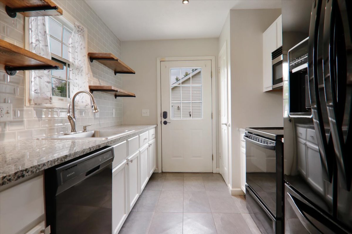 1401 River Landing Street Normal, IL 61761 - Photo 6 of 27 a kitchen with a sink and stainless steel appliances