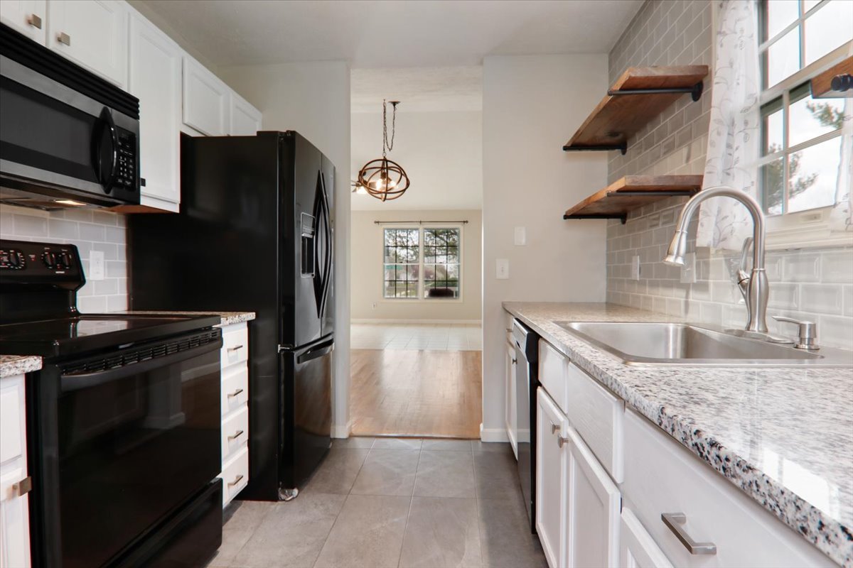 1401 River Landing Street Normal, IL 61761 - Photo 7 of 27 a kitchen with stainless steel appliances granite countertop a refrigerator a stove and a sink