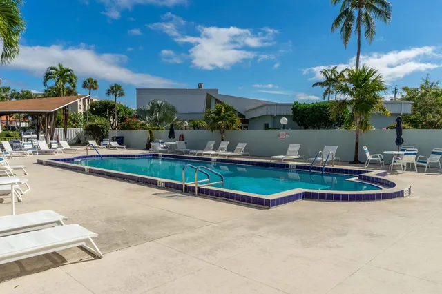 an outdoor space with swimming pool and furniture