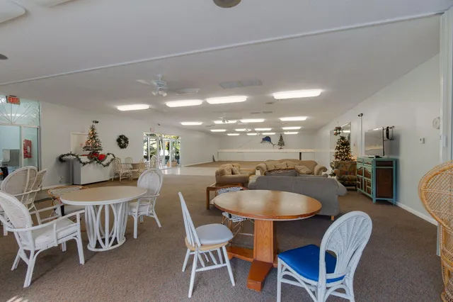 a dining room with furniture and a floor to ceiling window