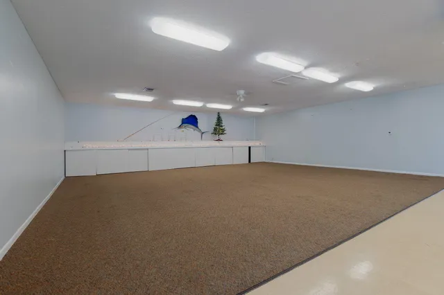 an empty room with a projector and cabinets