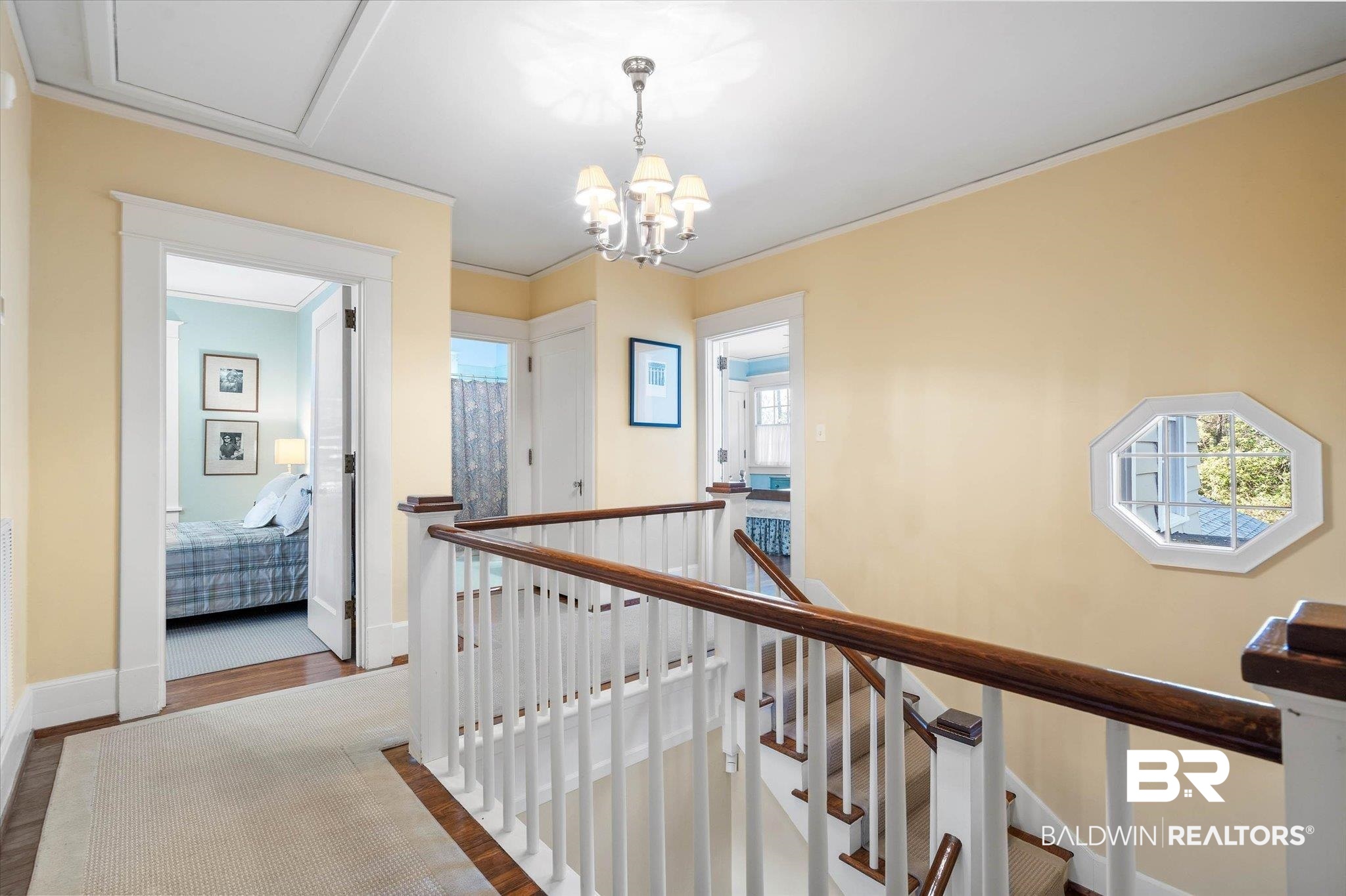 2 Westgate Road Mobile, AL 36608 - Photo 32 of 63 Hall featuring an upstairs landing, hanging lights, wood finished floors, and ornamental molding