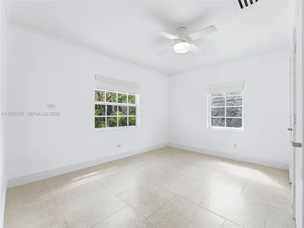 a view of a kitchen with refrigerator and wooden floor