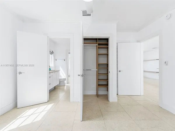 a spacious bathroom with a bathtub shower sink mirror and toilet