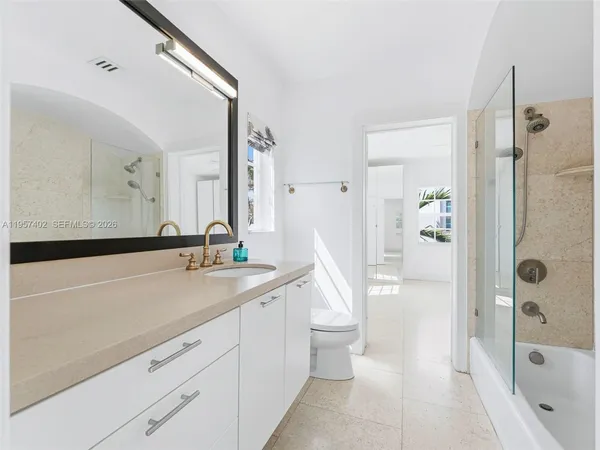 a spacious bathroom with a sink a mirror and a bathtub