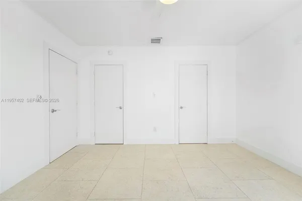 a view of yard from deck with patio