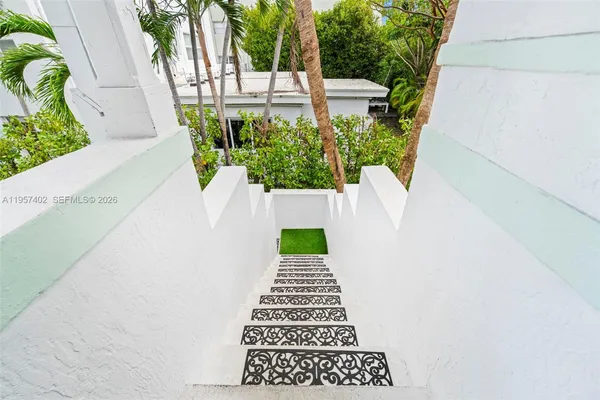 a view of a patio with couches table and chairs and potted plants