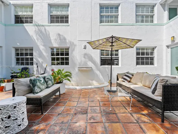 a wooden bench sitting in front of a building