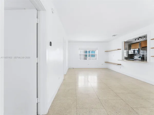 a view of a livingroom with furniture and a window