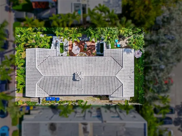 an aerial view of a house with a swimming pool yard and lake view in back