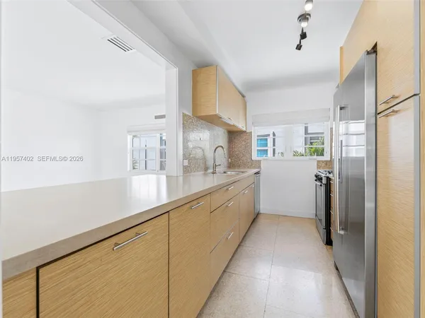 a kitchen with a refrigerator and a sink