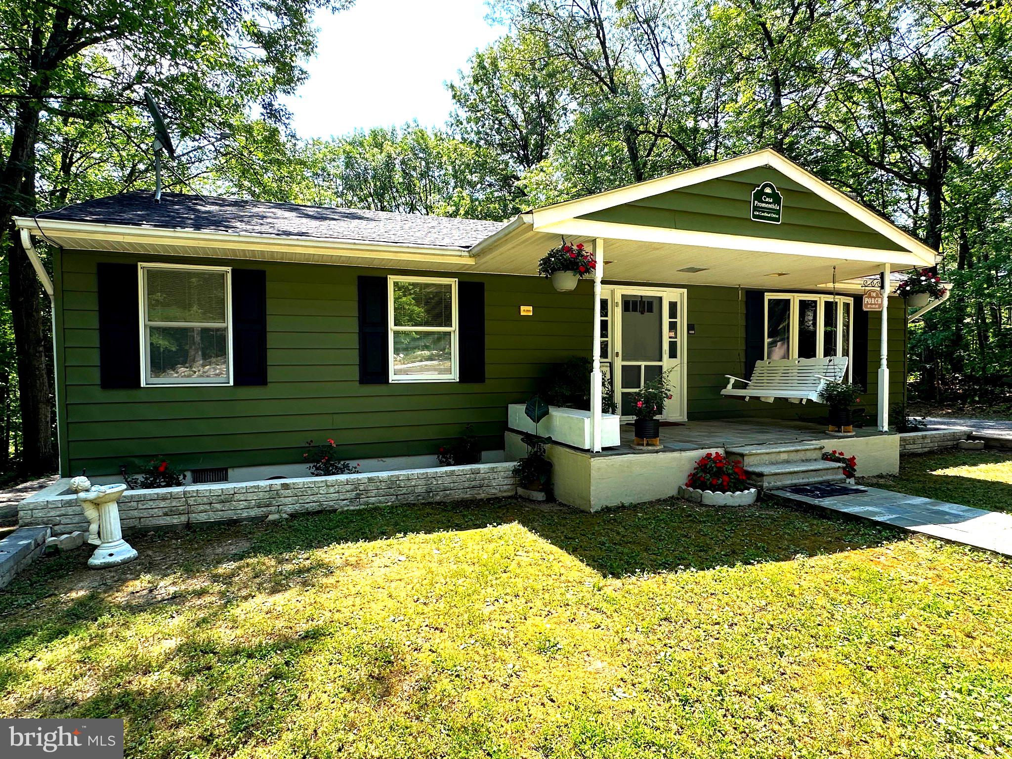 a front view of a house with a yard table and chairs