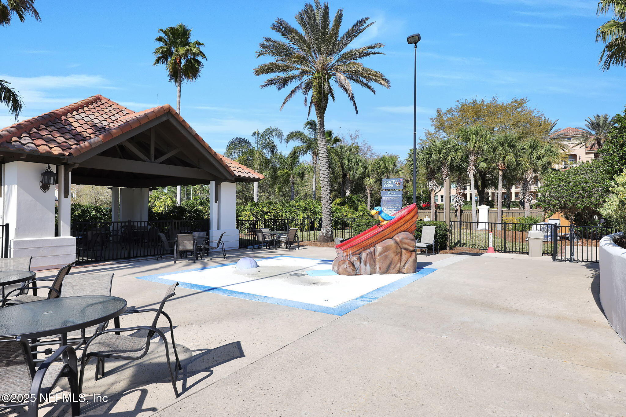 265 Oak Common Avenue St. Augustine, FL 32095 - Photo 109 of 116 a view of patio with a table and chairs under an umbrella
