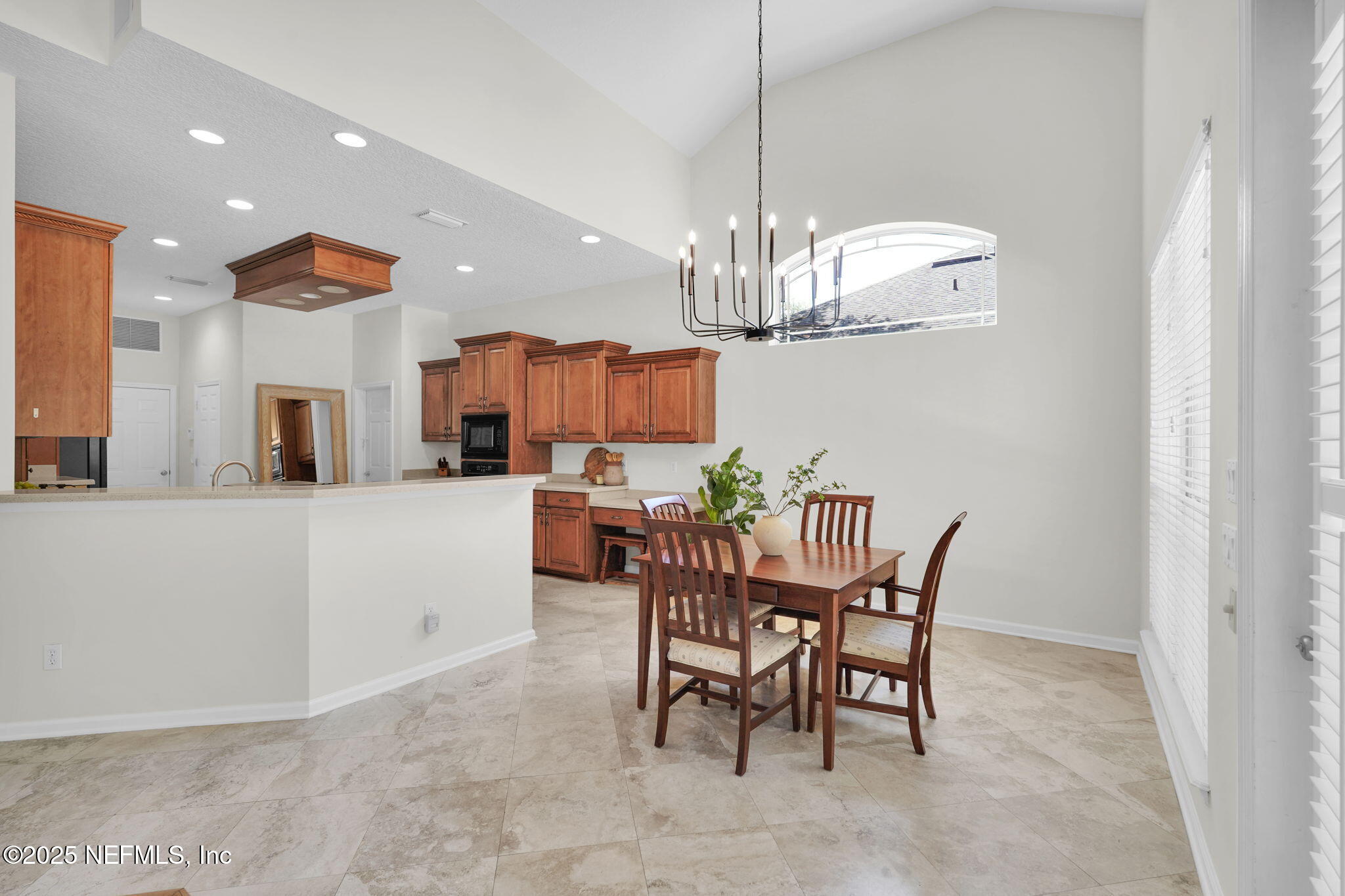265 Oak Common Avenue St. Augustine, FL 32095 - Photo 25 of 116 a view of a dining room with furniture and chandelier